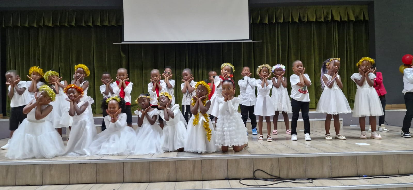 Pupils performing on stage during a school event